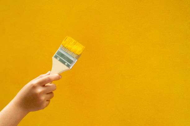 istock Yellow wall paint brush manual, repair, renovation 1329967536