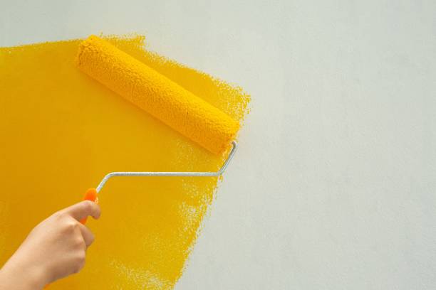istock Use a yellow paint roller to improve, fix, repair the house. 1329967537