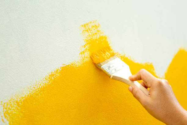 istock Use a brush to correct, improve, decorate, paint yellow manually. beautiful and economical 1329967562