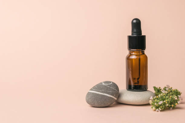 istock A composition of stones, a bottle with a pipette and medicinal herbs. 1329969086