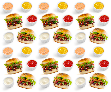 Seamless pattern of tasty burgers and different sauces isolated on white background.