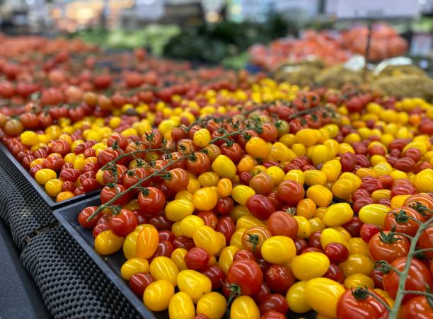 istock Fresh and Juicy mini Tomatoes on display 1329971100