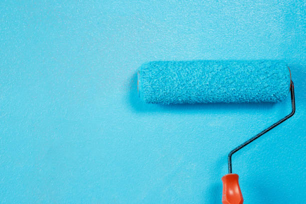 istock Painter is painting the interior wall Blue 1329974342