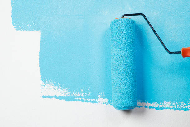 istock Painter is painting the interior wall Blue 1329974352