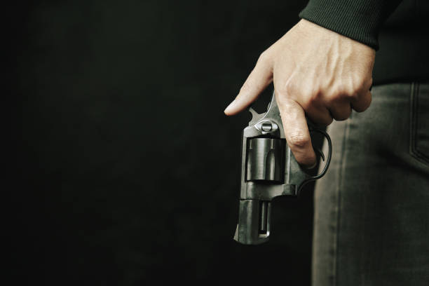 istock Black revolver with drum in man's hand. 1329974435
