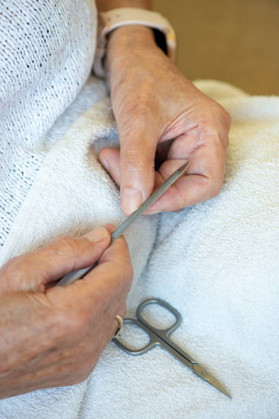 istock Senior Woman doing manicure with nail file. 1329978713