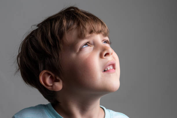 istock Pensive serious little boy looking up 1329979857