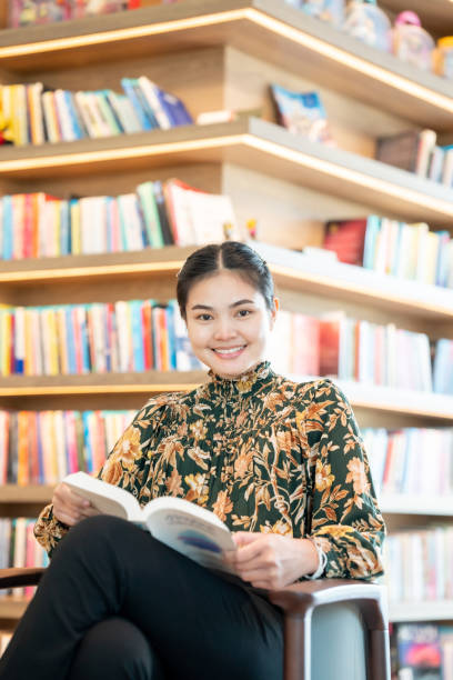 istock Women Reading a book in library 1329981729