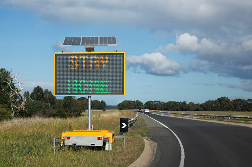Stay at home digital signage on Australian interstate highway during pandemic health warning lockdown.