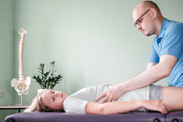 istock Osteopath practitioner releasing the diaphragm of a female patient, rib cage release massage, breathing muscle relaxation 1329989097