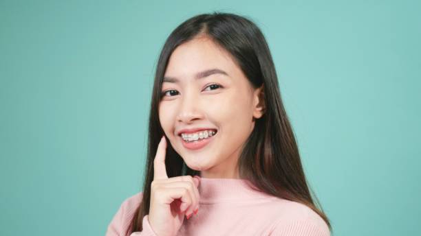 istock woman smiling wear silicone orthodontic retainers on teeth 1329990063