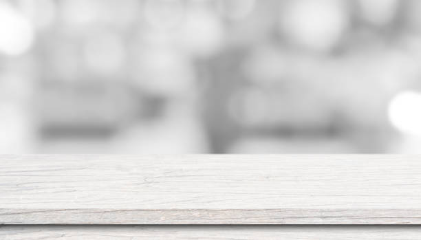 istock White wood table top over blur bokeh light background. 1329990219