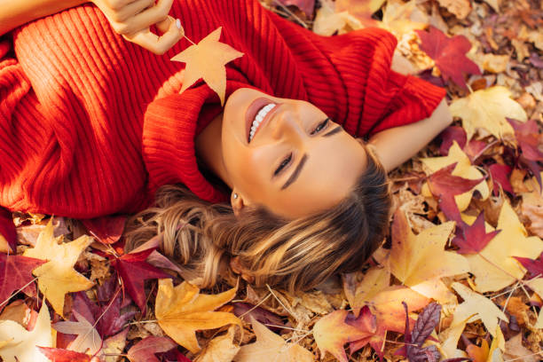 istock Beautiful woman lying on leaves 1329990336