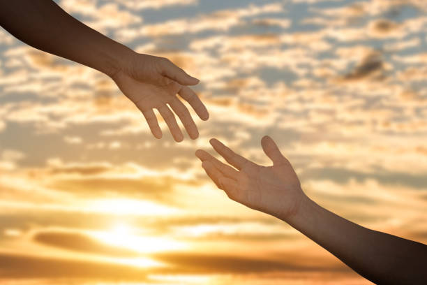 istock Giving a help hand concept. Reaching hand helping, hope and support 1329990347