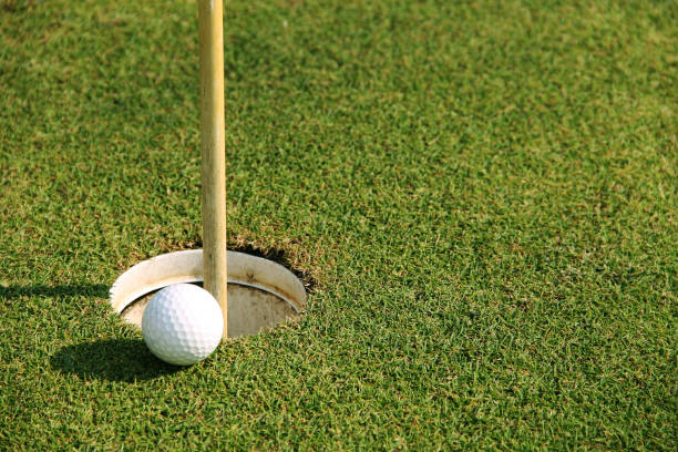 istock golf ball on tee in the evening golf course with sunshine 1329990931