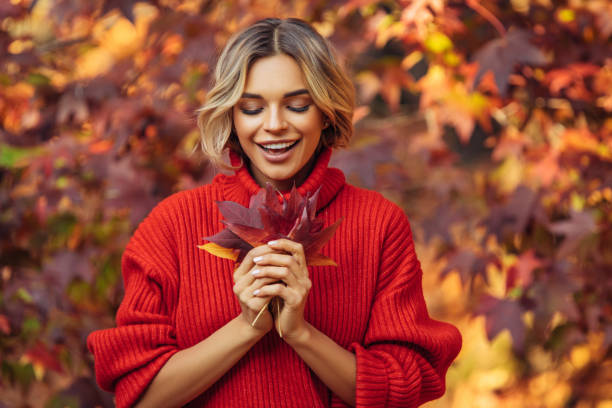 istock Beautiful woman holding a leaf 1329991091