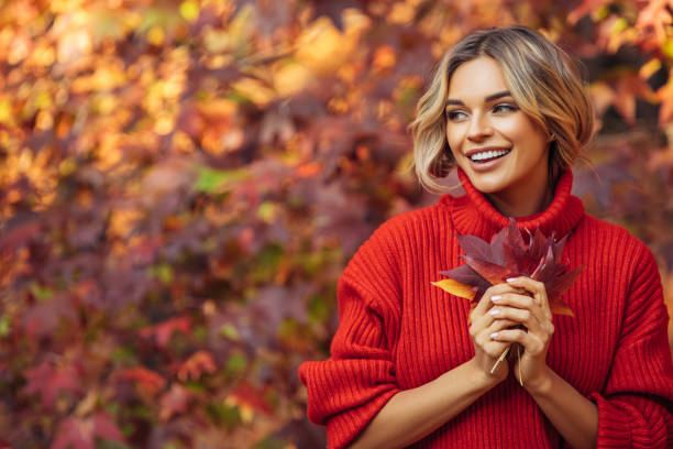 istock Beautiful woman holding a leaf 1329991118