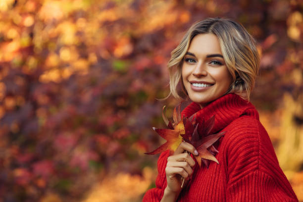 istock Beautiful woman holding a leaf 1329991140