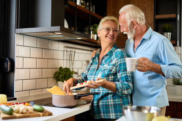 istock Senior couple in the kitchen preparing a meal 1329991363