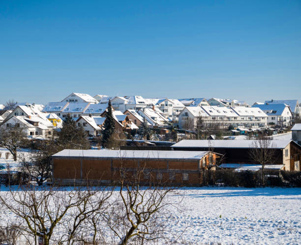 istock Snow-covered houses under a steel blue sky 1329993100