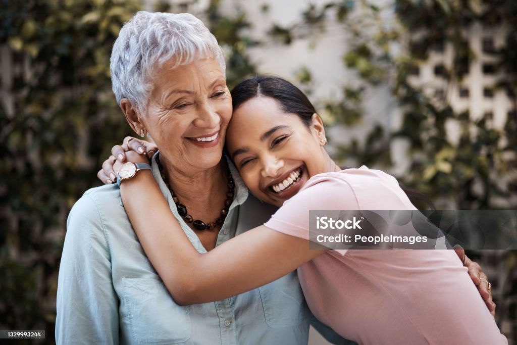 Shot of a senior woman spending time with her daughter in their garden at home You're never too grown to get cuddles from mom Mother Stock Photo