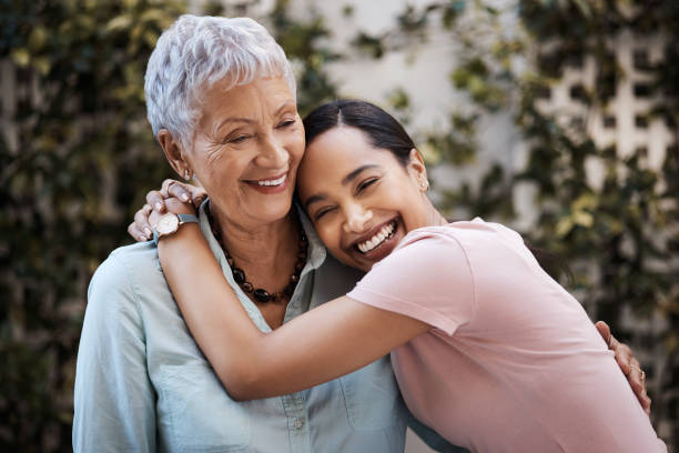 Shot of a senior woman spending time with her daughter in their garden at home You're never too grown to get cuddles from mom grandmother photos stock pictures, royalty-free photos & images