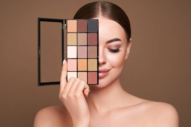 istock Beauty woman with eye shadow makeup palette 1329994142