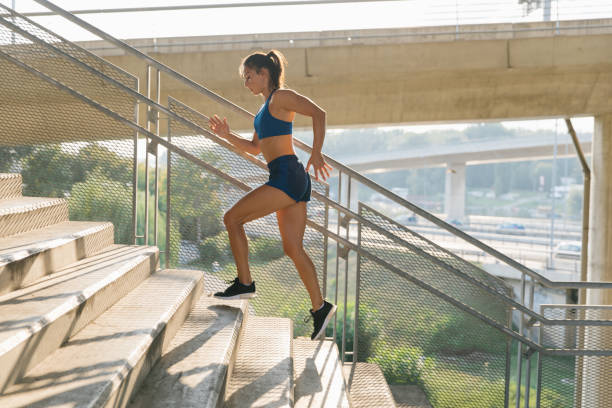 istock Young active woman running up the stairs 1329998653