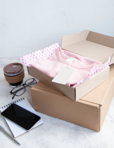 istock Clothes fir kids in an open cardboard box 1329999990