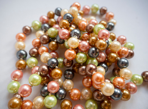 Multicolored pearl beads close-up on a white background