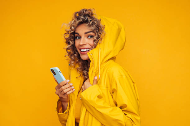 istock Beautiful smiling woman using smart phone 1330001455