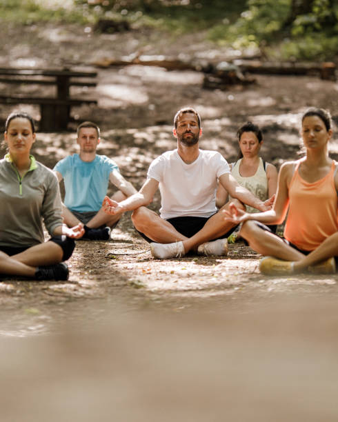 istock Group of athletes having Yoga class in nature. 1330003224