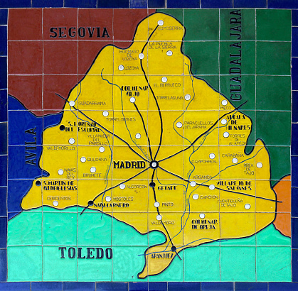 Image of the spanish capital city of Madrid painted on ceramic tiles in Spain Square in Seville, with the map of the region and the roads and villages around