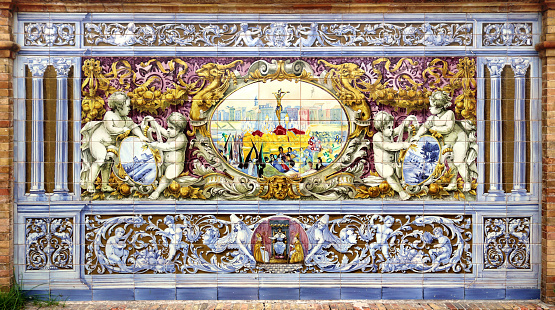 Image of easter procession in the the holy week of Sevilla painted on ceramic tiles representing the Spanish traditions - seating benches in Spain Square in Seville - This ornament belongs to the \