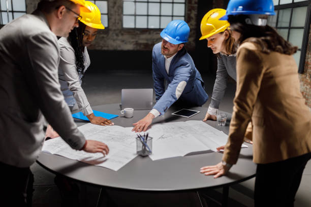 istock Team of architects analyzing blueprints in the office. 1330005101