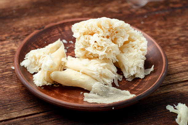 istock Hard cheese sliced chips on a clay plate on a wooden background. 1330005669