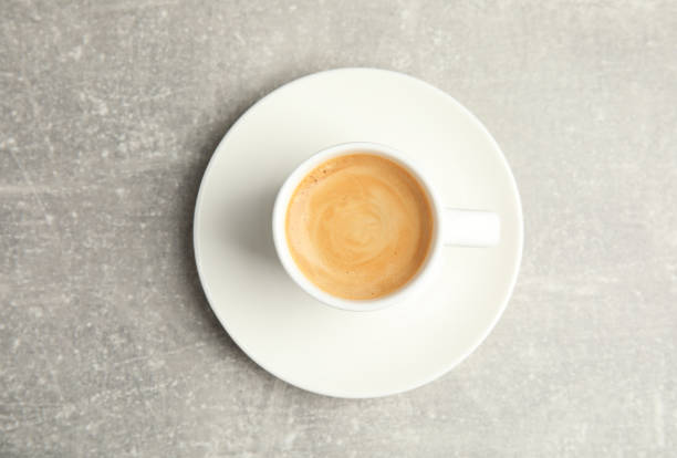 istock Cup of hot aromatic espresso on light table, top view 1330006104
