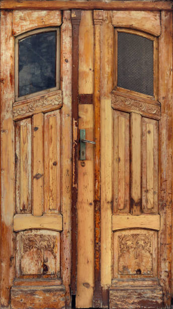 old worn door of wood with windows damaged and ornaments with ancient texture from an abandoned building - lock door horror gate imagens e fotografias de stock