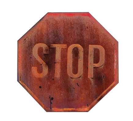 old, rusty and weathered stop sign isolated on a white background