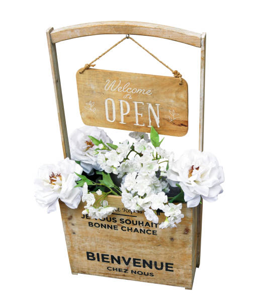 istock creative recycled wooden vase with white flowers and welcome panel, isolated with white background 1330006835