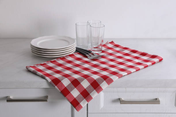 istock Dry kitchen towel and clean dishware on white marble countertop 1330007041