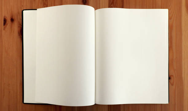 istock open blank sketchbook for drawing with empty curved double pages on a wooden table - education workplace desk background view from above 1330007235