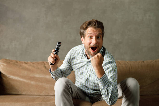 istock Cheerful man celebrating while watching a sports game on TV. 1330008138