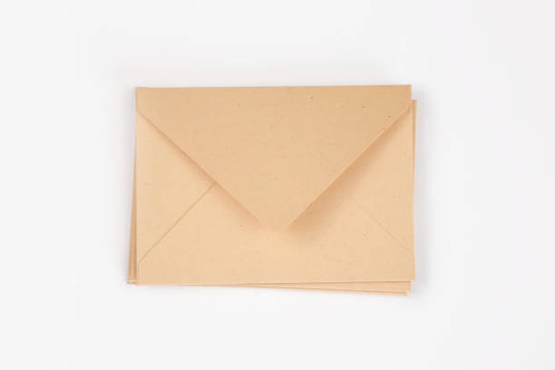 istock Stack of light brown paper open envelope on white isolated background. Three craft envelopes for invitations, certificates or cash gifts. Mockup, template, square envelope flap. 1330009393