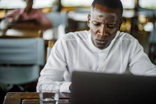 istock Worried black businessman working on laptop. 1330009520