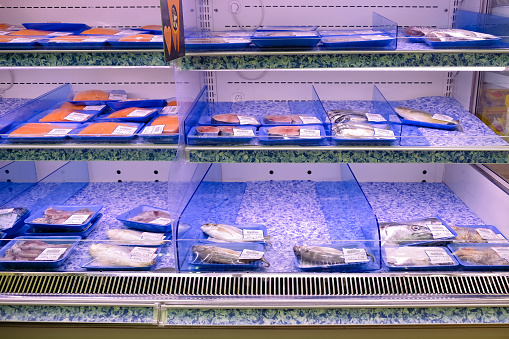 Low selection of pre packed fresh raw fish displayed on shelves for sale in supermarket. Due to recent covid-19 cluster in fishery port, fresh seafood is in short supply