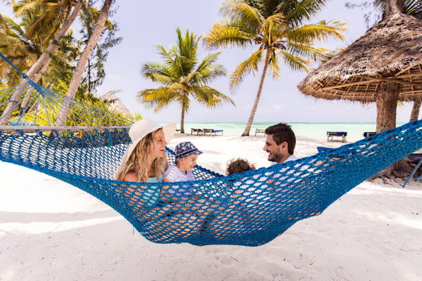 istock Happy family talking in hammock on the beach. 1330009897