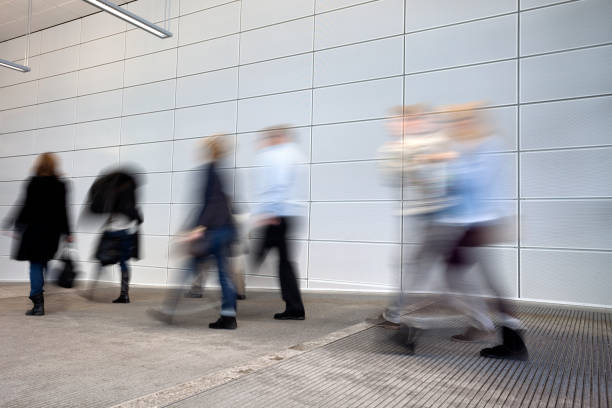istock Businesspeople Walking Through White Hallway 1330010678