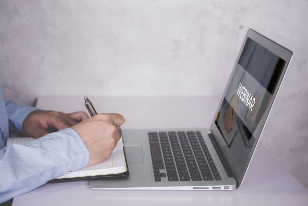istock Hand of man watching webinar on laptop computer and writing on notebook for learning, education with e-learning online, video conference and training, seminar course, knowledge and study with digital. 1330010854