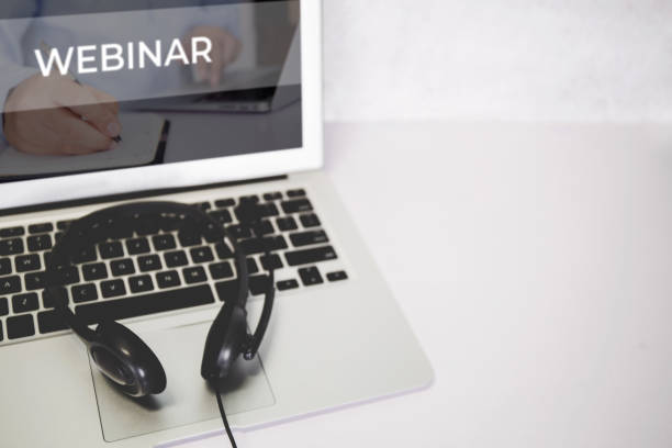 istock Laptop computer and headphone on desk, e-learning online, webinar for education and learning, seminar with notebook, video conference, headset for multimedia, course and classroom to internet. 1330010916
